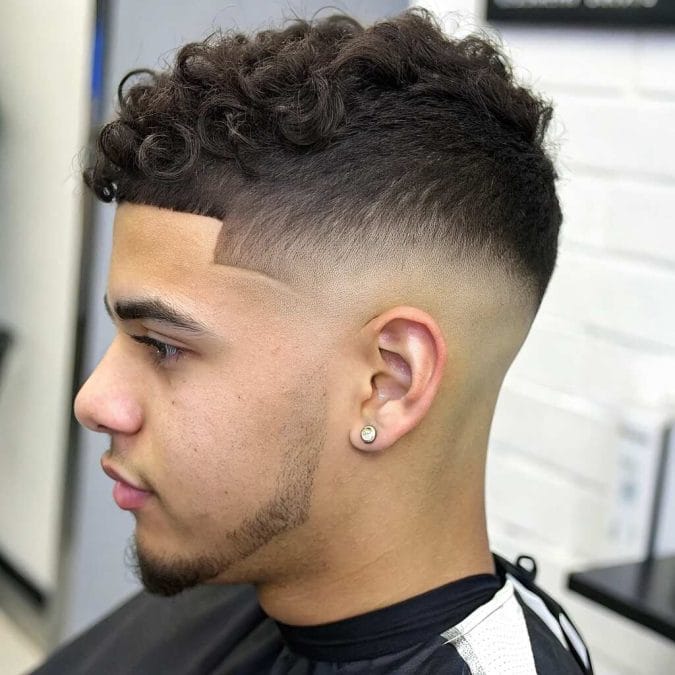 Burst fade around the ear paired with a mullet